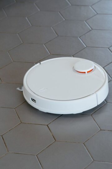 A modern automatic vacuum sealer preserving fresh basil on a bright kitchen countertop.